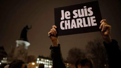 A man holds a placard which reads "I am Charlie" to pay tribute during a gathering at the Place de la Republique in Paris